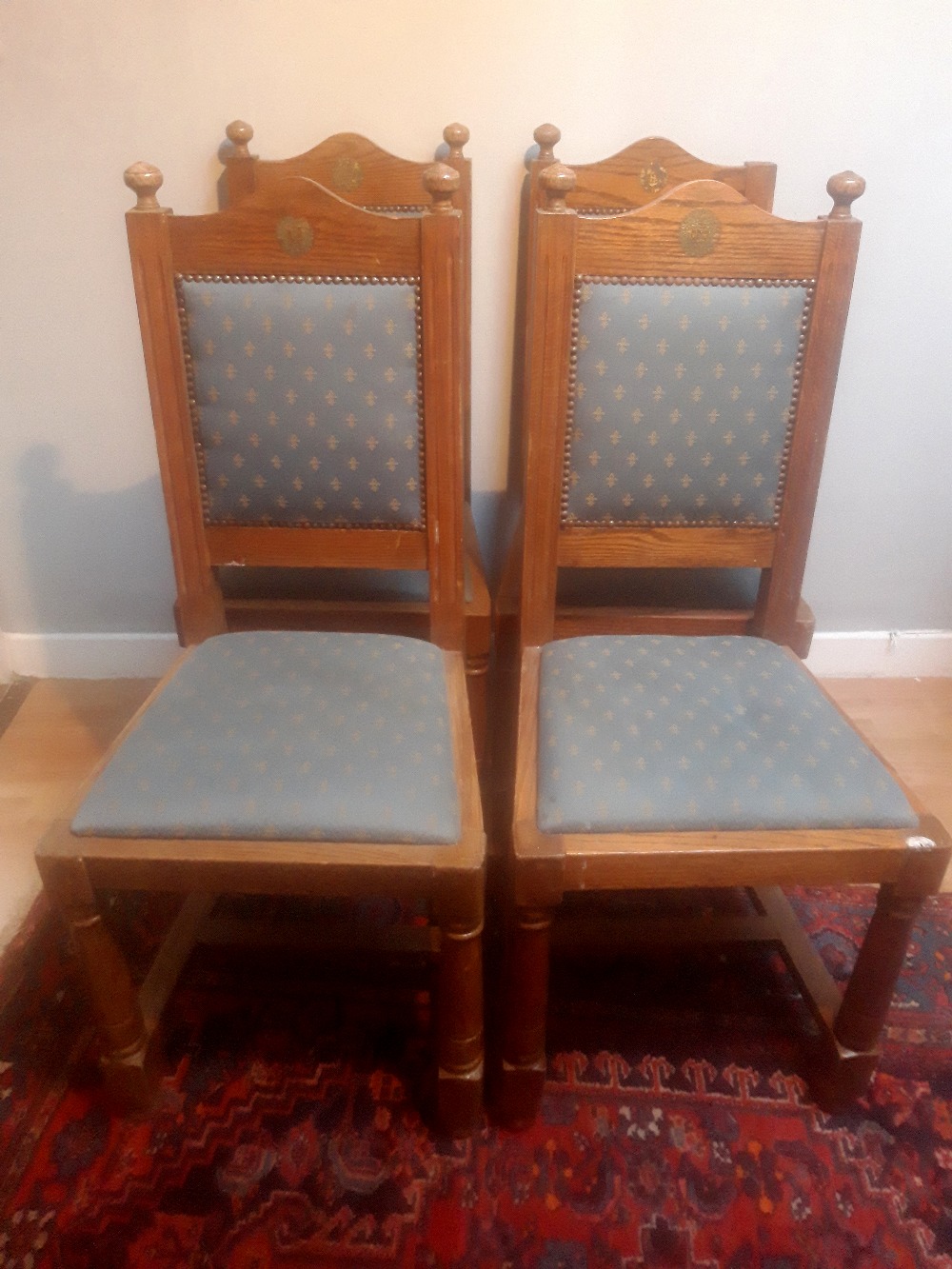A SET OF FOUR IRISH ARMY CHAIRS, oak, with square padded back support having turned finials to the