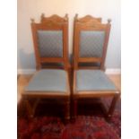 A SET OF FOUR IRISH ARMY CHAIRS, oak, with square padded back support having turned finials to the