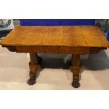 A REGENCY IRISH AMBOYNA LIBRARY TABLE, with leaf and scroll decoration, standing on a plinth base on