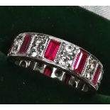 A SOLID 9CT WHITE GOLD BAGUETTE CUT RUBY AND ROUND CUT DIAMOND RING, full eternity style ring with