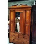 AN EARLY 20TH CENTURY WALNUT WARDROBE with three drawers beneath mirrored hanging section, 7ft 6in