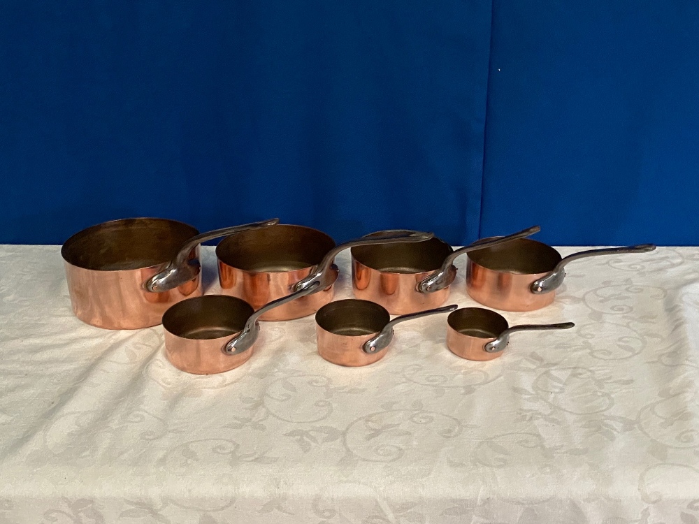 A SET OF COPPER SAUCEPANS