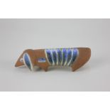 A 20th century Lisa Larson Gustavsberg Swedish pottery figure of a Dachshund, with blue stripe back,