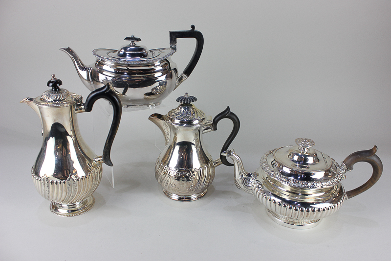 A silver plated circular teapot with demi-fluted decoration, an oval teapot, and two baluster shaped