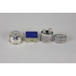 A silver filigree miniature scent bottle holder, oval form with two compartments holding silver