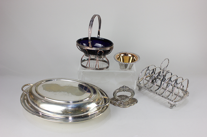 An Elkington & Co silver plated six-division toast rack, an oval basket with blue glass liner, a