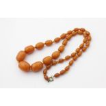 A butterscotch amber necklace strung with graduated beads