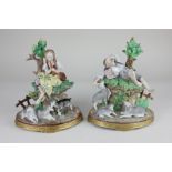 A pair of Sitzendorf porcelain figures of a shepherd sleeping and a shepherdess playing a flute,