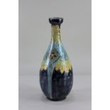 A Della Robbia pottery bottle neck vase, with floral design on purple and blue ground, the base