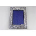 An Edward VII silver photograph frame with embossed Art Nouveau design, maker J & R Griffin,