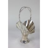 A George V silver vasiform basket, faceted form with pierced swing handle, engraved initials and