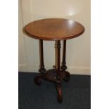A Victorian walnut inlaid side table, the circular top with scrolling foliate decoration, on
