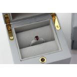 A ruby and diamond ring by Kat Florence, the oval cut stone claw set with pave set diamond claws and