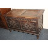A carved oak coffer, with two panel decoration front and frieze, on block feet, 110cm