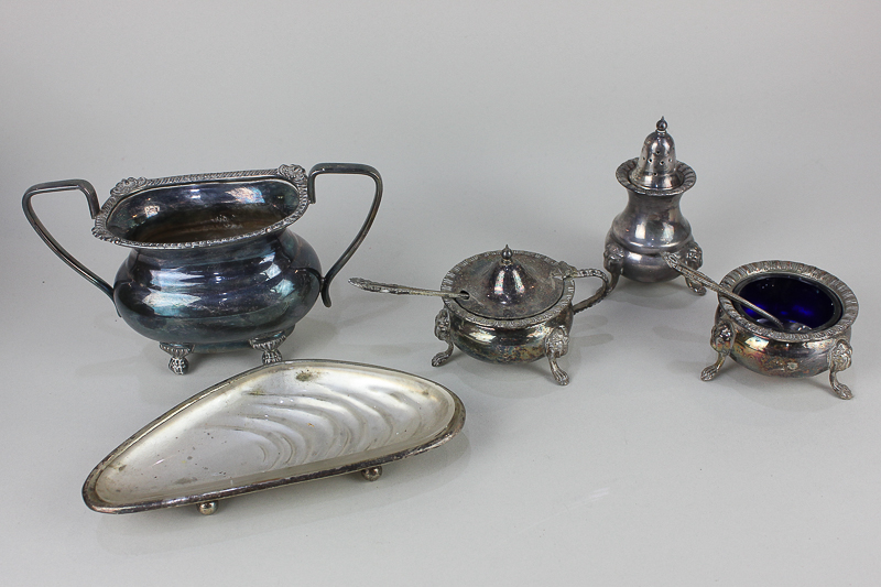 A silver plated three-piece cruet set, circular salt, mustard pot together with blue glass liners