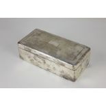 A George V silver rectangular cigarette box with engine turned engraved lid (a/f - hinges strained),