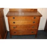 An oak chest of four graduated drawers, with rectangular top, the drawers with circular stamped