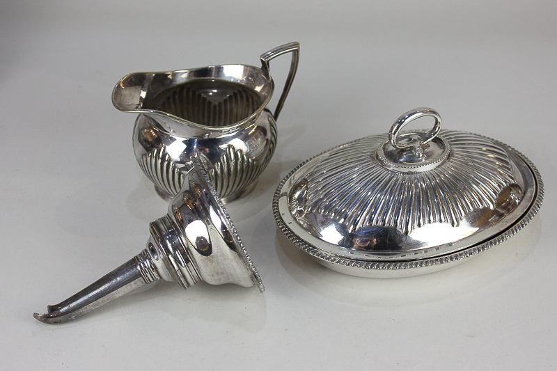 A silver plated wine funnel, with gadrooned border, a small oval tureen and cover, with reeded