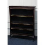 A 19th century mahogany open bookcase with a moulded top and blind fretwork frieze above three