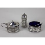A George V silver three-piece cruet set with pierced decoration, oval mustard pot, salt and pepper