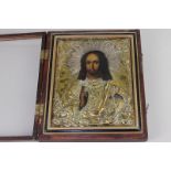 A Russian icon of Jesus Christ, with gilt metal oklad within glazed display case, 18cm by 21.5cm