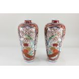 A pair of Japanese porcelain vases, of slender baluster form, decorated in the Imari palette with