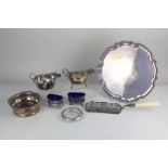 A silver plated pie crust salver, two sauce boats, a bottle coaster with engraved presentation,