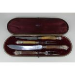 A silver mounted horn handled four-piece carving set, cased (a/f - one fork guard missing)