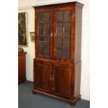 A George III walnut glazed bookcase, with two panel glazed doors enclosing three shelves, and