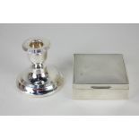 An Edward VII silver dwarf candlestick, on loaded circular base, 8cm high, and a modern silver