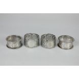 Two pairs of George V silver napkin rings, one set pierced, the other with engraved decoration, 2.