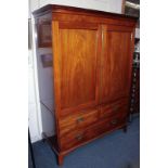 A Victorian mahogany linen press with panelled doors enclosing four sliding trays, above two short