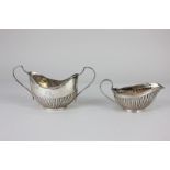 A Victorian silver cream jug, oval shape with reeded decoration, Birmingham 1886, 1.8oz, and a