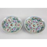 A pair of Chinese famille rose porcelain saucers, decorated with character symbols, butterflies, and