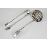 A pair of George III silver sugar tongs, with bright cut engraved decoration, London 1794, and a