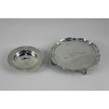A modern silver waiter tray, with pie crust border and engraved presentation inscription, on four