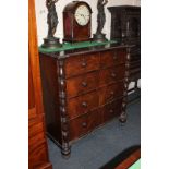 A Victorian carved mahogany chest of two short over three long drawers, flanked by baluster column