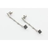 A pair of diamond drop two way earrings, loose hung with a square of nine black diamonds from a