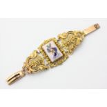 A 19th century gilt bracelet with enamel centre panel (replaced clasp)