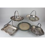 Four various silver plated serving baskets, each with swing handle, and a circular stand with wooden