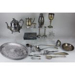 A collection of silver plated tableware to include a Victorian teapot, two soup ladles, oval serving