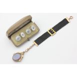 A pair of gold and mother of pearl cufflinks, and a black silk watch fob hung with a swivel seal