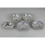 Two pairs of Victorian silver circular bonbon dishes with pierced and embossed decorative borders,