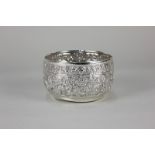 An eastern white metal sugar bowl with embossed decoration of animals in a forest, 3.5oz, 10cm