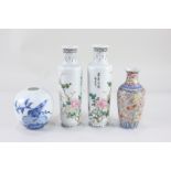 A pair of small Chinese porcelain vases, of cylindrical form, decorated with birds on flowering