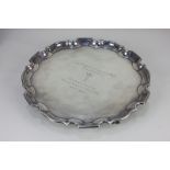 A modern silver salver, with pie crust border, and presentation inscription, on three claw and