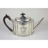 A George III silver teapot, oval serpentine form and straight tapered spout, with engraved borders