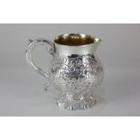 A Scottish silver cream jug with embossed floral decoration, gilt interior and scroll handle, 6oz,