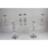 A pair of silver plated three branch candelabra 31cm high