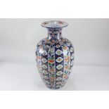 A Japanese porcelain vase, of baluster form with fluted neck, decorated with vertical bands of